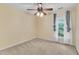 Cozy bedroom with neutral carpet, ceiling fan, and a window with curtains at 605 Catlin Rd, Cary, NC 27519