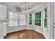 Bright breakfast nook with hardwood floors, many windows and stylish lighting at 605 Catlin Rd, Cary, NC 27519