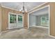 Formal dining room featuring a chandelier, large window, and beige carpet at 605 Catlin Rd, Cary, NC 27519