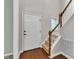 Inviting foyer with a front door, hardwood floors, and carpeted stairs leading to the upper level at 605 Catlin Rd, Cary, NC 27519