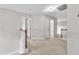 Second-floor hallway with neutral carpet, white doors, and access to bedrooms and bathrooms at 605 Catlin Rd, Cary, NC 27519
