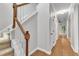 Hallway features hardwood floors and stairs with white risers and wood handrail, leading to the upper level at 605 Catlin Rd, Cary, NC 27519