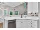 Close-up of kitchen sink and counter with stainless dishwasher and white cabinetry at 605 Catlin Rd, Cary, NC 27519