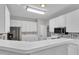 Kitchen with white cabinets, stainless appliances, and raised breakfast bar at 605 Catlin Rd, Cary, NC 27519