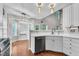 Kitchen featuring breakfast nook, white cabinets, stainless dishwasher, and wood floor at 605 Catlin Rd, Cary, NC 27519