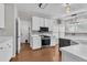 Bright eat-in kitchen featuring stainless appliances, white cabinets, and wood flooring at 605 Catlin Rd, Cary, NC 27519