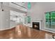 Inviting living room featuring a fireplace, high ceilings, wood floors, and seamless flow to the kitchen at 605 Catlin Rd, Cary, NC 27519