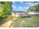 Well maintained backyard with a wooden deck, shed, and a lush green lawn at 609 N Country Club Dr, Oxford, NC 27565