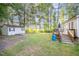 Spacious backyard featuring a deck, shed, and a view of the lake at 609 N Country Club Dr, Oxford, NC 27565