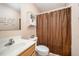 A bathroom with a toilet, sink, and a bathtub behind a curtain at 609 N Country Club Dr, Oxford, NC 27565