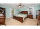 Cozy bedroom with wood bed frame, ceiling fan, and natural light from the window at 609 N Country Club Dr, Oxford, NC 27565