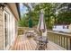 Outdoor wooden deck area with patio table, chairs, and backyard views at 609 N Country Club Dr, Oxford, NC 27565