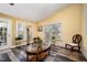 Open-concept living space with seating and dining area with an ornamental glass top coffee table at 609 N Country Club Dr, Oxford, NC 27565