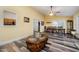 Sunny dining room with wood flooring, chandelier, and view into sitting room at 609 N Country Club Dr, Oxford, NC 27565