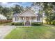 Charming home featuring a covered front porch, manicured lawn, and inviting curb appeal at 609 N Country Club Dr, Oxford, NC 27565