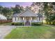 Charming home featuring a covered front porch, manicured lawn, and inviting curb appeal at 609 N Country Club Dr, Oxford, NC 27565