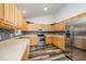 This kitchen features stainless steel appliances, wood cabinets, and a stylish backsplash at 609 N Country Club Dr, Oxford, NC 27565