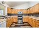 This kitchen features wooden cabinets, stainless steel appliances, and ample counter space at 609 N Country Club Dr, Oxford, NC 27565
