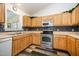 This kitchen features light wooden cabinets and stainless steel appliances at 609 N Country Club Dr, Oxford, NC 27565