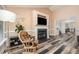 Cozy living room with a fireplace, mounted television, and unique wood flooring at 609 N Country Club Dr, Oxford, NC 27565