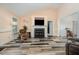 Bright living room with fireplace, tv, and view into the dining room at 609 N Country Club Dr, Oxford, NC 27565