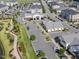 Aerial view of a community with shops, parking lots, and landscaped green spaces at 6612 Enrichment Ln, Raleigh, NC 27616
