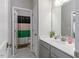 Bathroom with a modern vanity and view into the shower with colorful curtain at 6612 Enrichment Ln, Raleigh, NC 27616