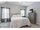 Neutral bedroom with a comfortable bed, lots of light and a TV on the dresser at 6612 Enrichment Ln, Raleigh, NC 27616