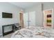 Bedroom featuring a comfortable bed, TV and views to the closets and bathroom at 6612 Enrichment Ln, Raleigh, NC 27616