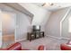 Bonus room featuring slanted ceilings and a mounted TV for entertainment at 6612 Enrichment Ln, Raleigh, NC 27616