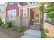 Inviting entrance with brick steps leading to a charming front porch and decorative wreath at 6612 Enrichment Ln, Raleigh, NC 27616