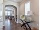 Bright entryway with hardwood floors, stylish console table, and arched doorway to living room at 6612 Enrichment Ln, Raleigh, NC 27616