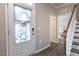 Welcoming foyer features a staircase and a view to the front porch and bedroom at 6612 Enrichment Ln, Raleigh, NC 27616