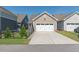 Spacious two-car garage with a long driveway, complemented by manicured greenery at 6612 Enrichment Ln, Raleigh, NC 27616
