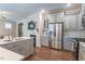 Spacious kitchen with stainless steel appliances, gray cabinetry, white countertops and wood flooring at 6612 Enrichment Ln, Raleigh, NC 27616