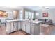 Open floorplan features a kitchen island with white countertops and stainless steel appliances overlooking living space at 6612 Enrichment Ln, Raleigh, NC 27616