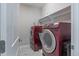 Laundry room features a modern washer and dryer set with a shelf for storage at 6612 Enrichment Ln, Raleigh, NC 27616