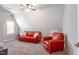 Sitting area with a cozy red sofa and chair, perfect for relaxing or entertaining guests at 6612 Enrichment Ln, Raleigh, NC 27616