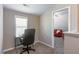 Bright office area with natural light and a view into a cozy sitting area at 6612 Enrichment Ln, Raleigh, NC 27616