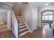 Open staircase showcases hardwood steps leading to the upper level of the home at 6612 Enrichment Ln, Raleigh, NC 27616