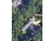 An aerial view of a home surrounded by dense trees, providing privacy and a natural setting at 71010 Russell, Chapel Hill, NC 27517