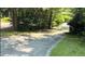 Long driveway with mature trees and landscaping, providing a private entrance to the property at 71010 Russell, Chapel Hill, NC 27517