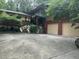 Home featuring a two-car garage, lush landscaping, and a charming stone staircase at 71010 Russell, Chapel Hill, NC 27517