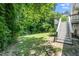 Home's exterior featuring stairs to the deck with a large backyard at 725 E Maple Ln, Fuquay Varina, NC 27526