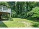 Backyard showing a deck with stairs and a circular hardscape at 725 E Maple Ln, Fuquay Varina, NC 27526