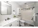Modern bathroom with sleek vanity, matte black fixtures, subway tile shower, and gray flooring at 725 E Maple Ln, Fuquay Varina, NC 27526