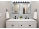Bathroom vanity with double sinks, patterned backsplash and decorative mirrors at 725 E Maple Ln, Fuquay Varina, NC 27526