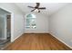 Bedroom with hardwood floors, big window and architectural window for natural light at 725 E Maple Ln, Fuquay Varina, NC 27526