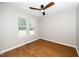 Bright bedroom with two windows and a modern ceiling fan at 725 E Maple Ln, Fuquay Varina, NC 27526