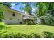 Home's exterior featuring a backyard with a deck and lush green lawn at 725 E Maple Ln, Fuquay Varina, NC 27526